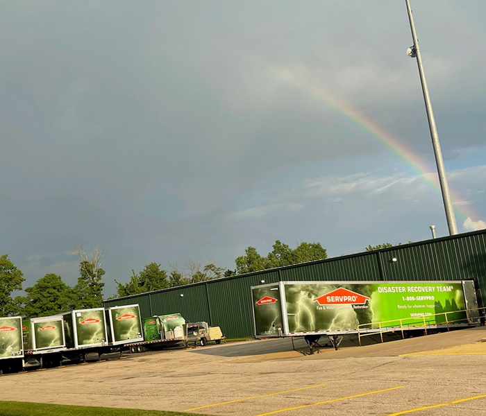 SERVPRO trucks with a rainbow in the background