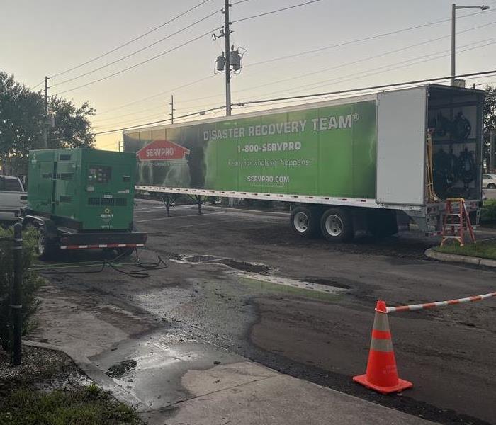 SERVPRO truck outside of a flooded building following a storm
